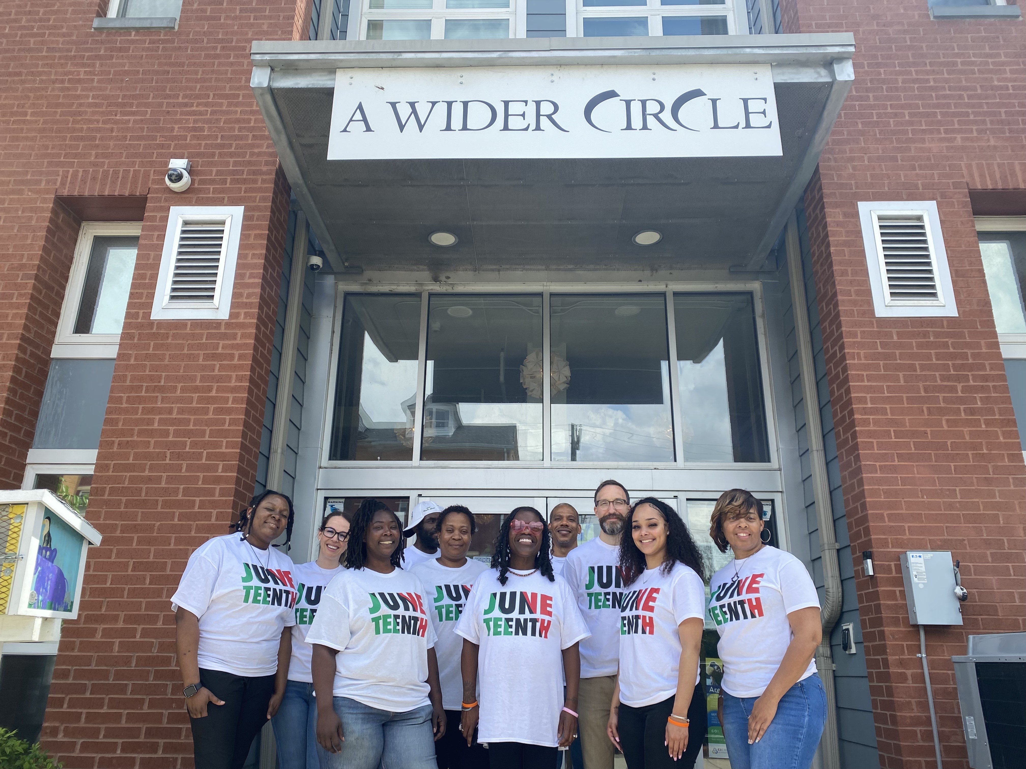 Jasmine with the A Wider Circle team in front of their Ward 8 Office
