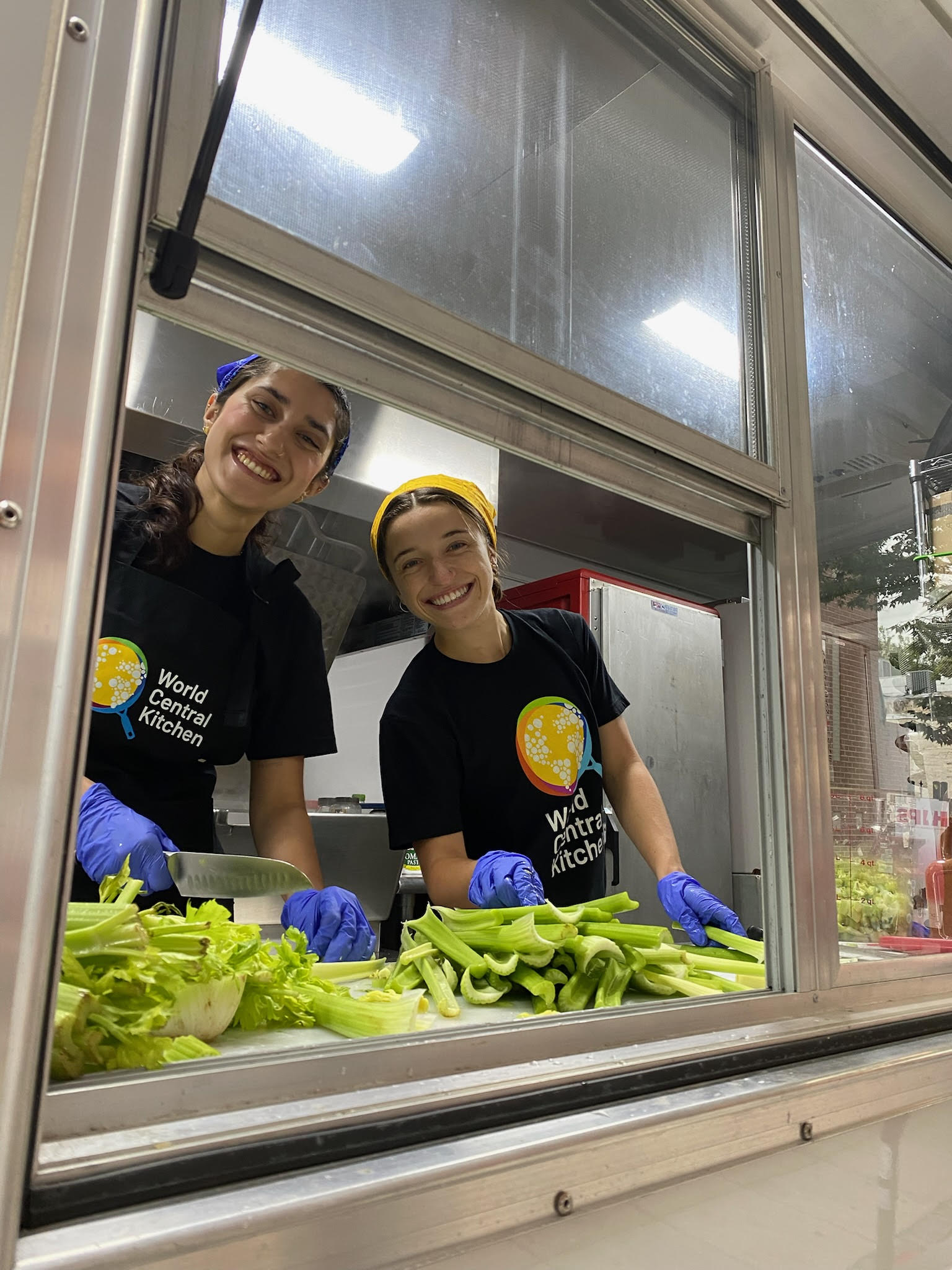 Callie and Anika cutting vegetables during their activation event in SHAW.