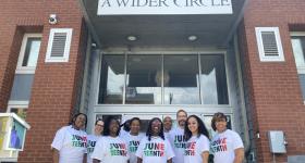 Jasmine with the A Wider Circle team in front of their Ward 8 Office